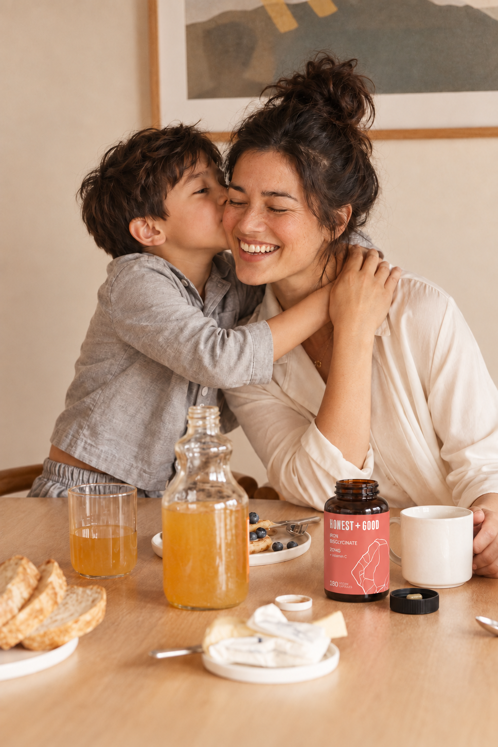A mum and her son hugging at the breakfast table with Honest + Good Iron Bisglycinate + Vitamin C